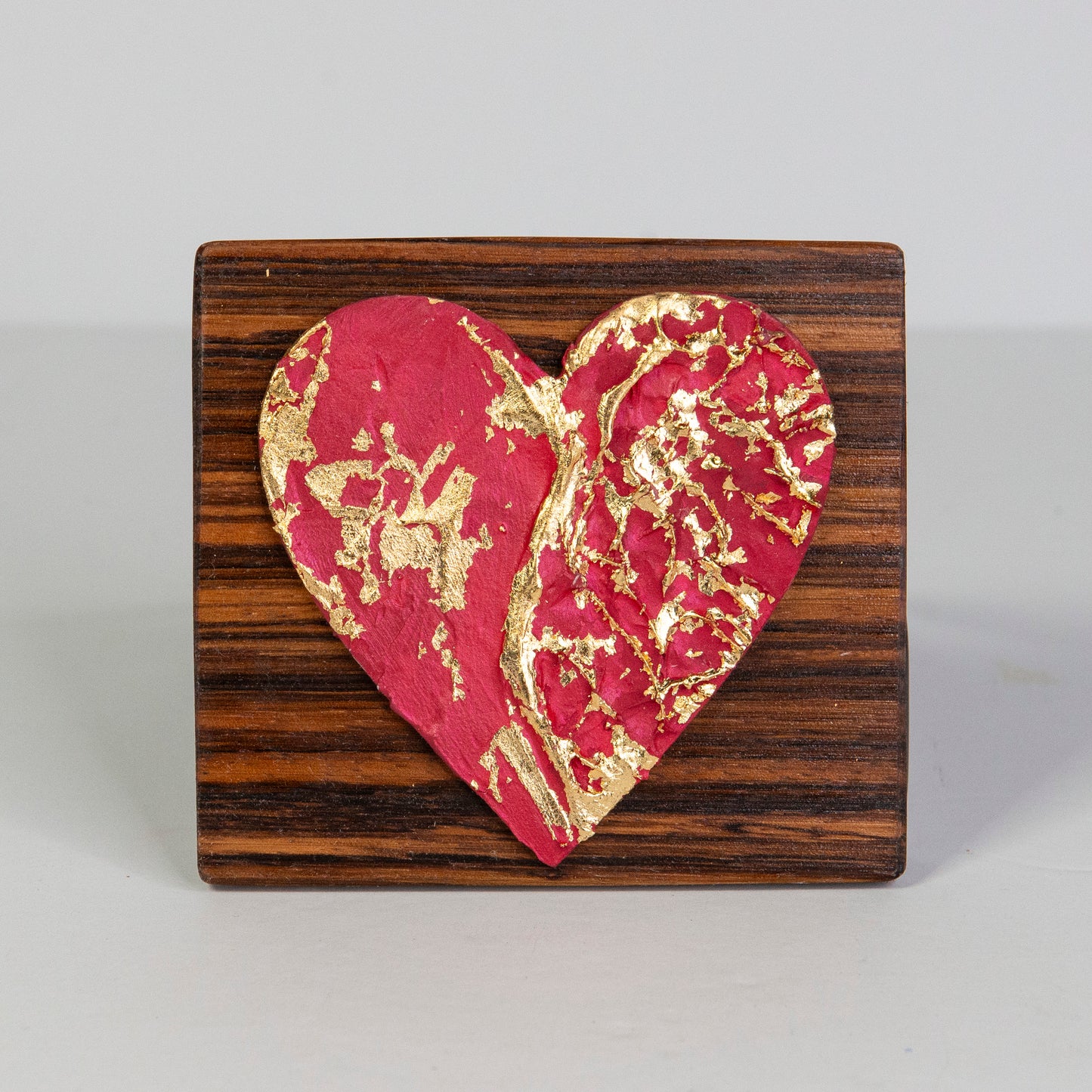 Metal art heart on wood