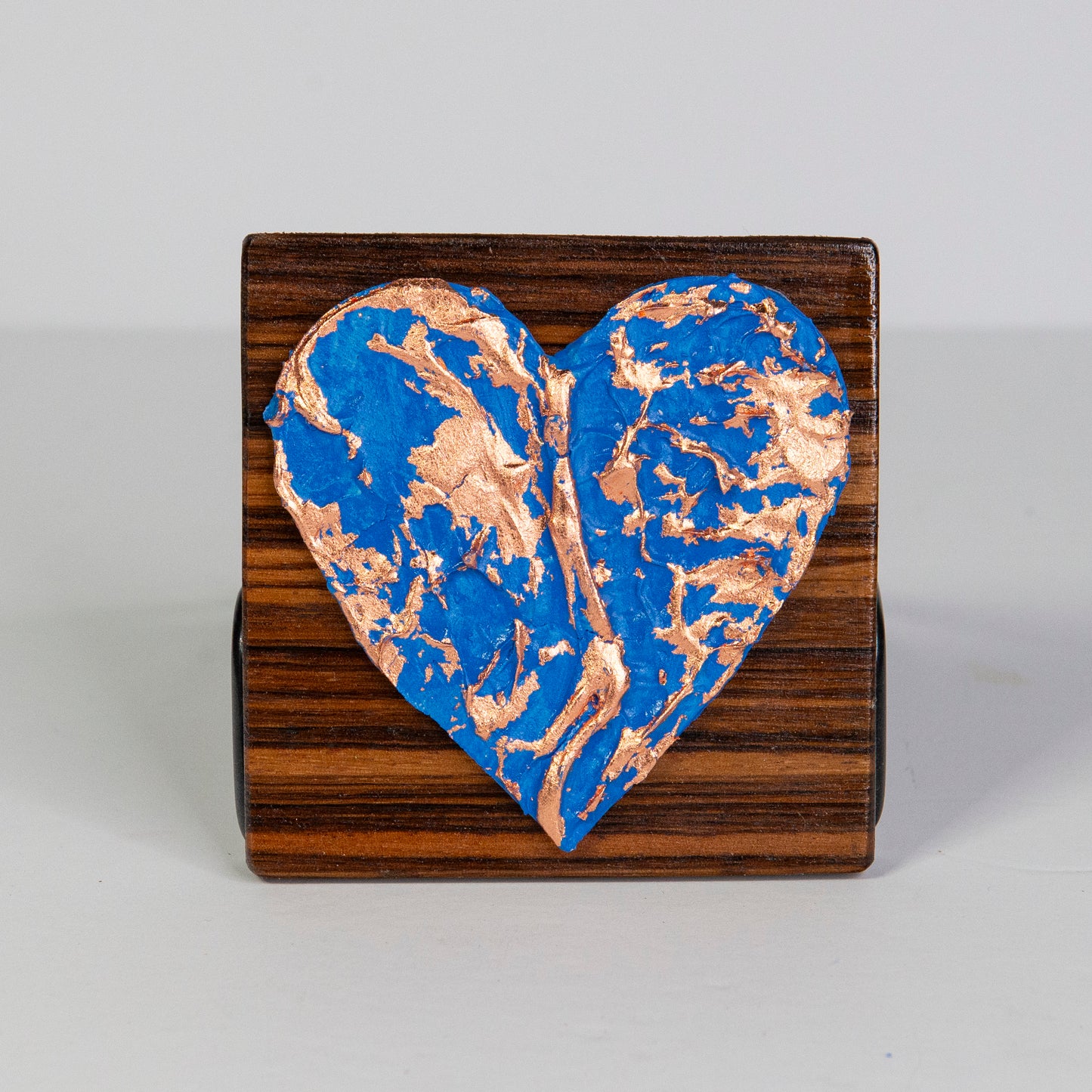 Metal art heart on wood