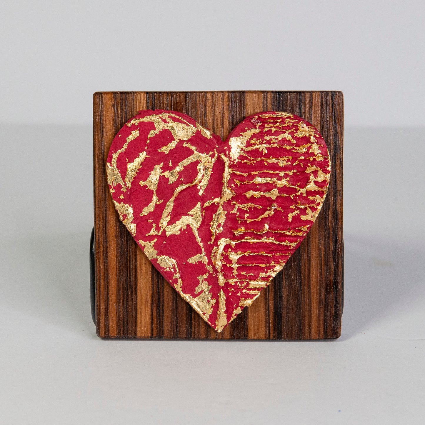 Metal art heart on wood