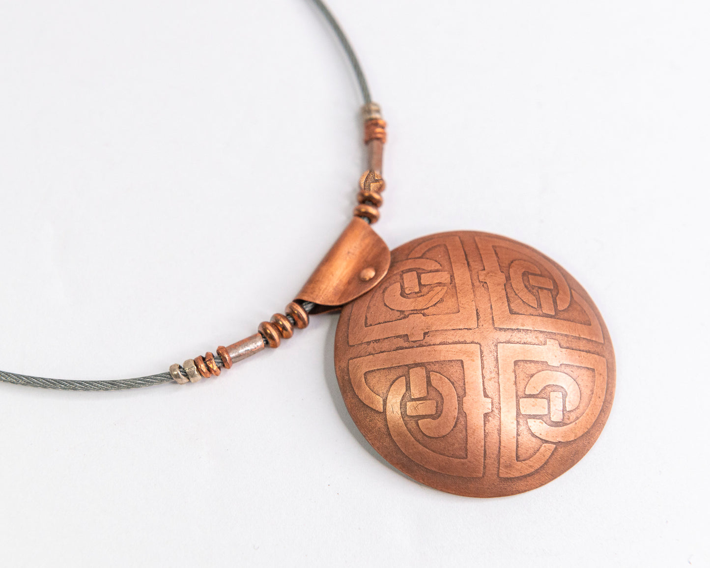 Etched Celtic ornate knot pendant.