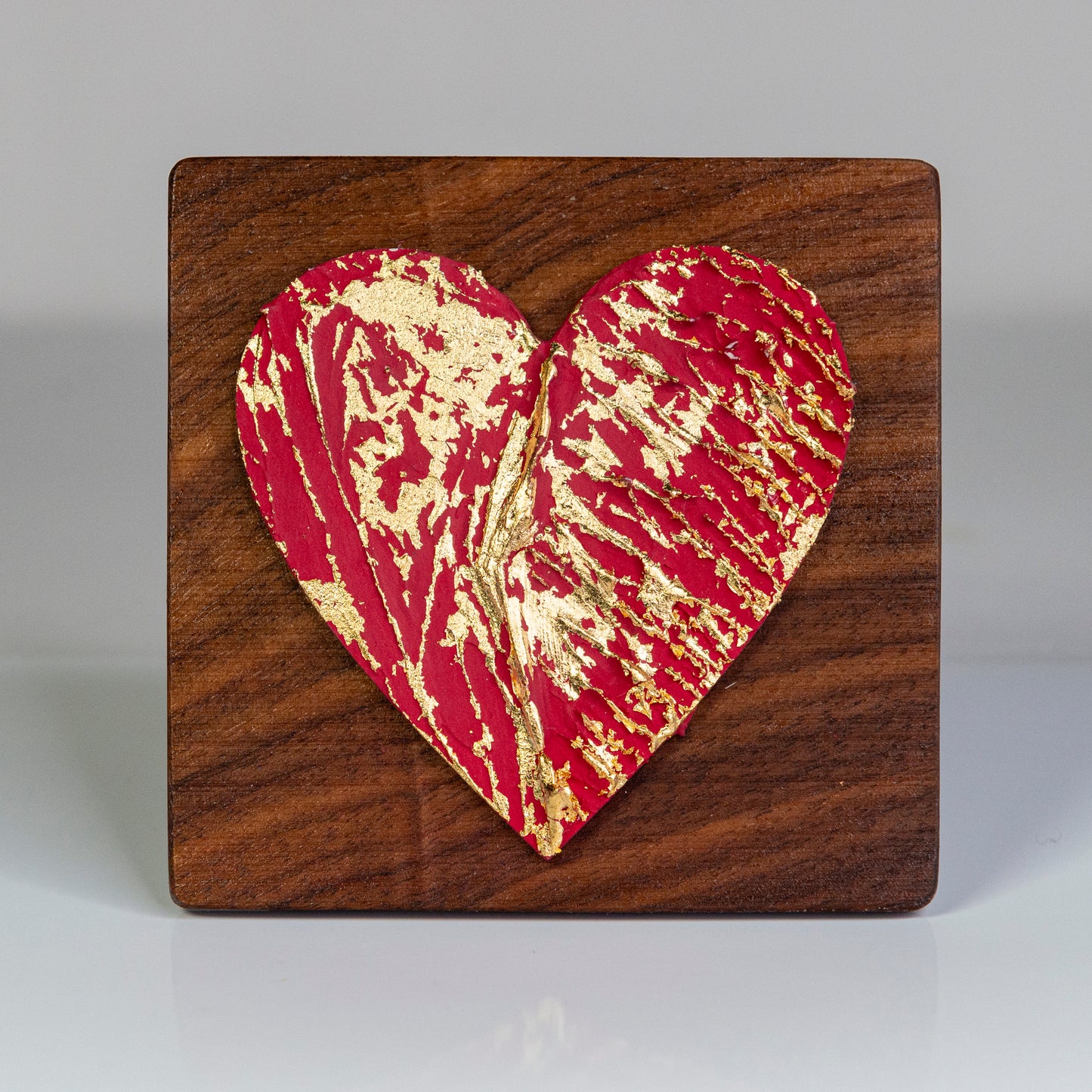 Metal art heart on wood