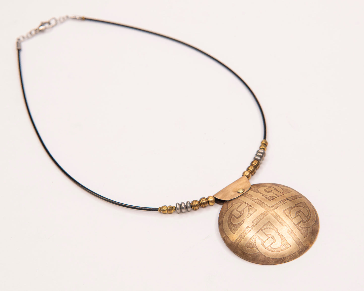 Etched Celtic ornate knot pendant.