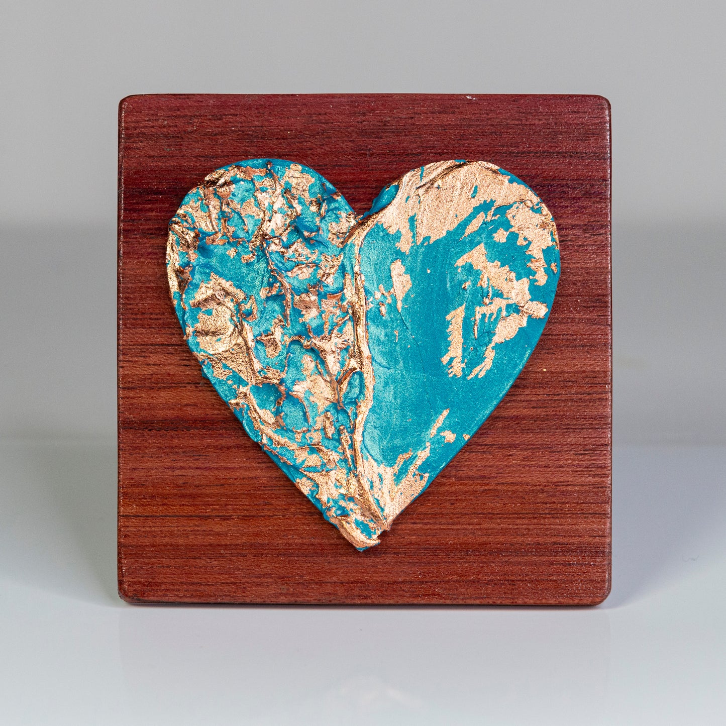 Metal art heart on wood