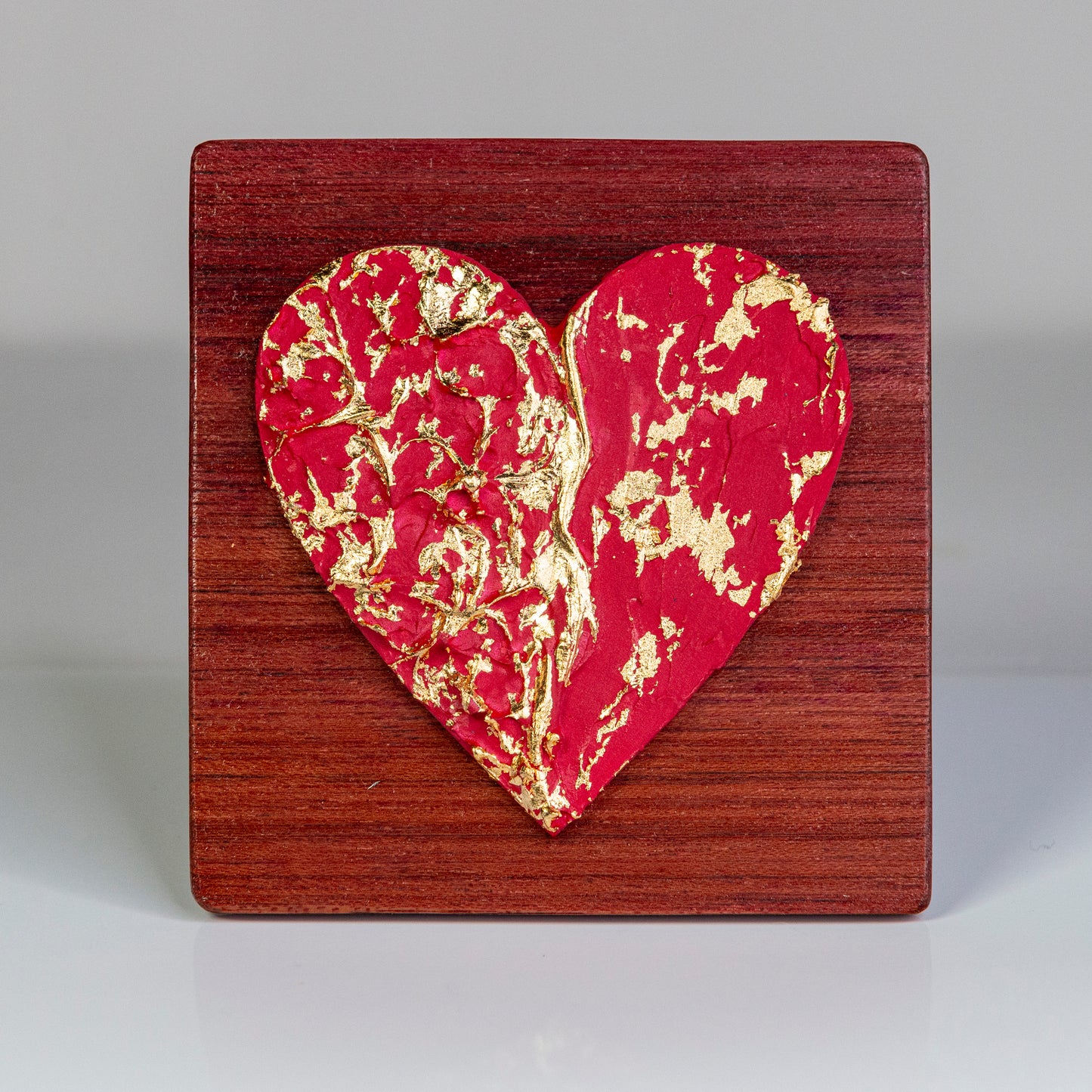 Metal art heart on wood