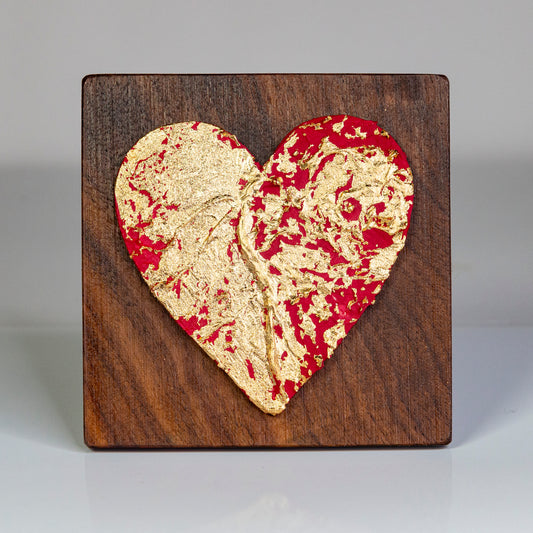 Metal art heart on wood